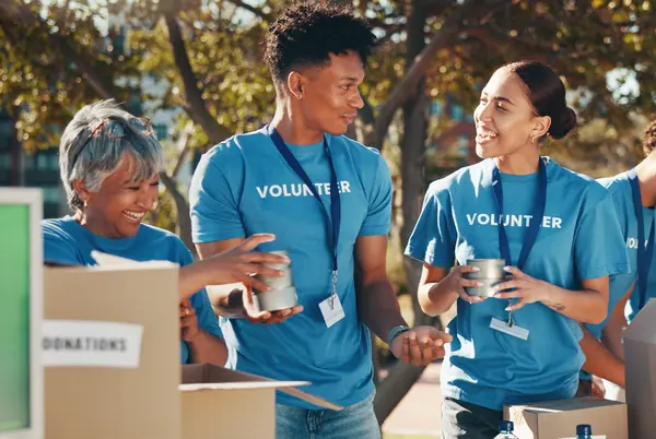 Volunteers in blue T-shirts packing donation boxes